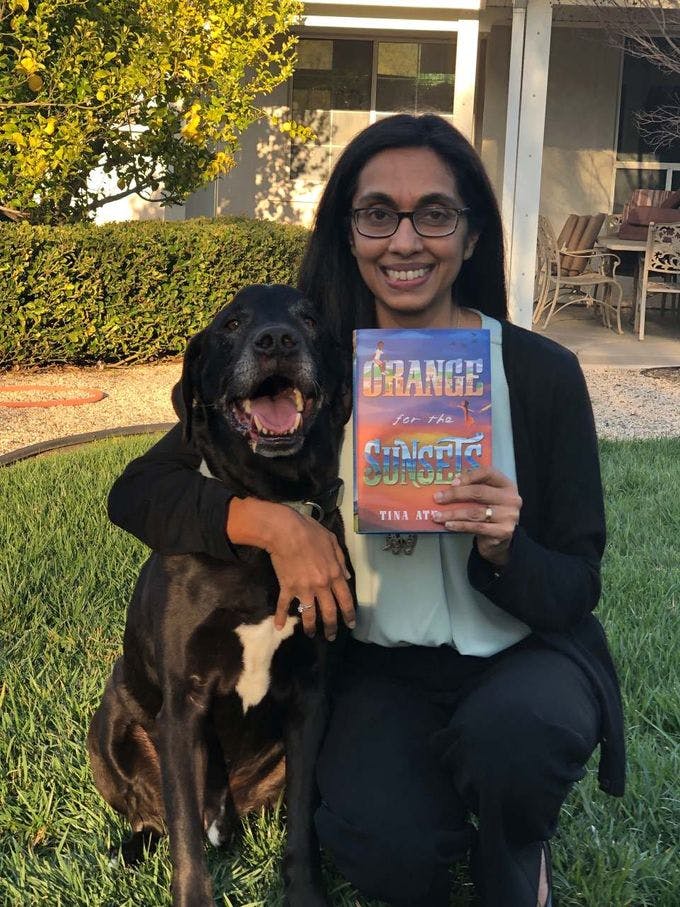 Author Tina Athaide with her dog, Butler, on the day her book, Orange for the Sunsets, arrived.