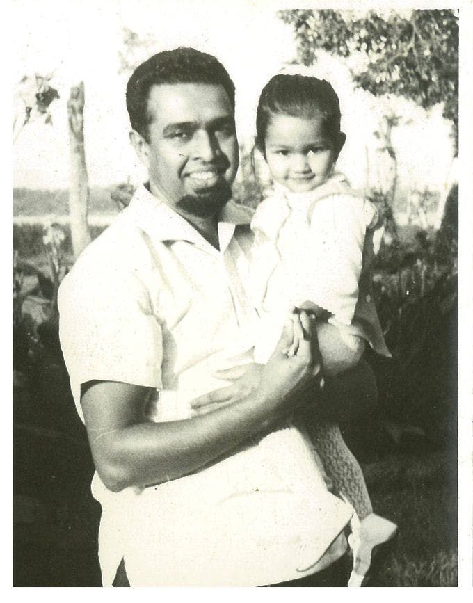 Author Tina Athaide as a young girl with her father at the botanical gardens.