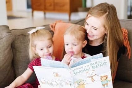 Mom reading to two girls